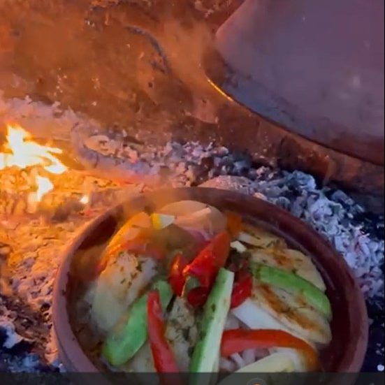 Rugged building entrance in a hilly terrain with eroded surroundings.
