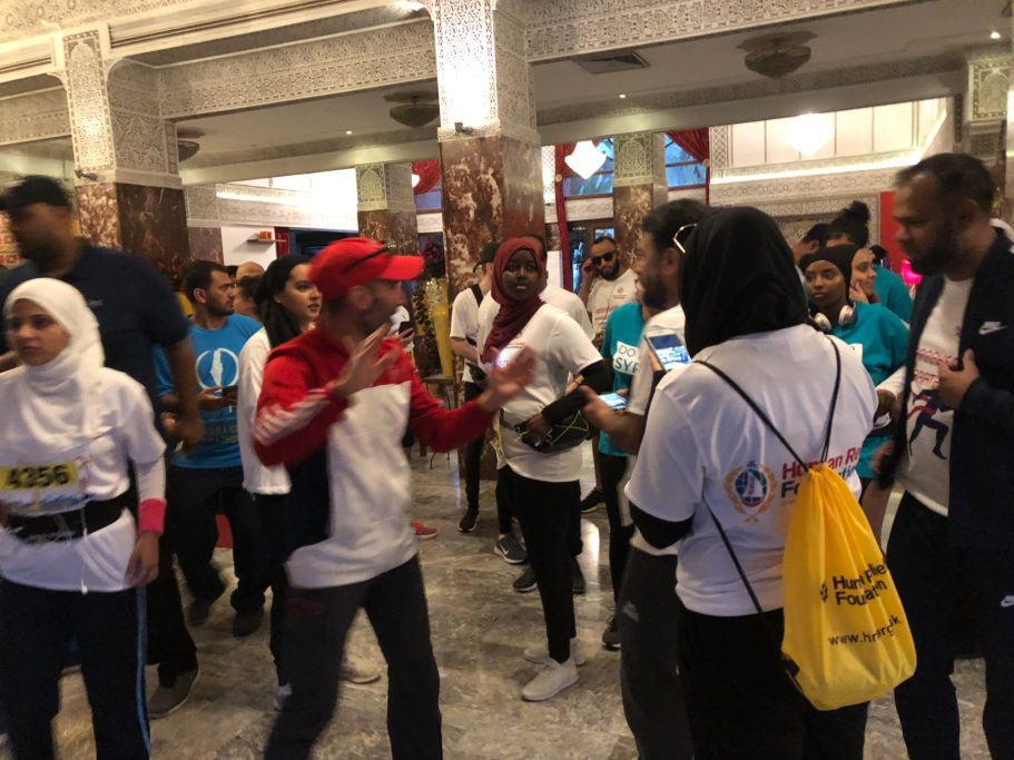 A diverse group of people in casual attire engaging in a lively discussion indoors.
