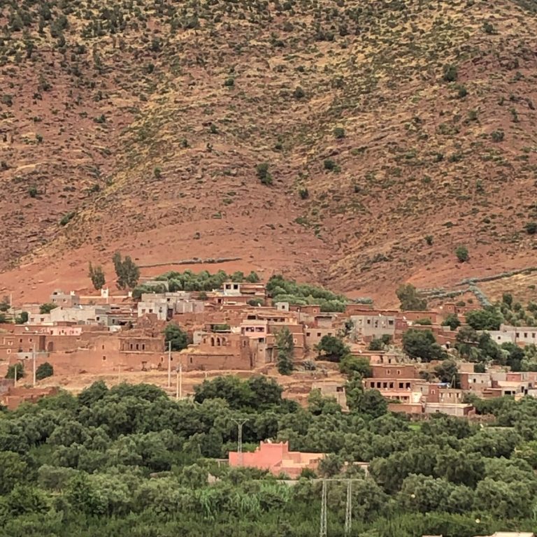 View of a traditional village nestled against a mountainous landscape.