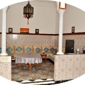 Traditional Moroccan living space with decorative tiles and elegant seating.