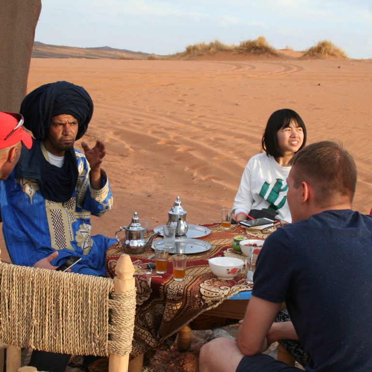 Signpost depicting "Tombouctou 52" with a camel and desert scene.