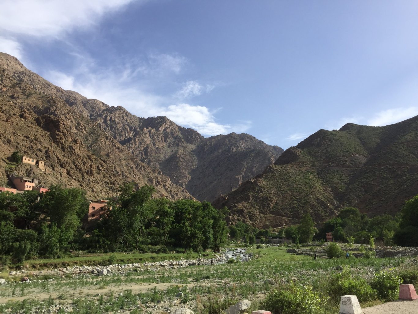 Mountainous landscape with greenery and a clear blue sky.
