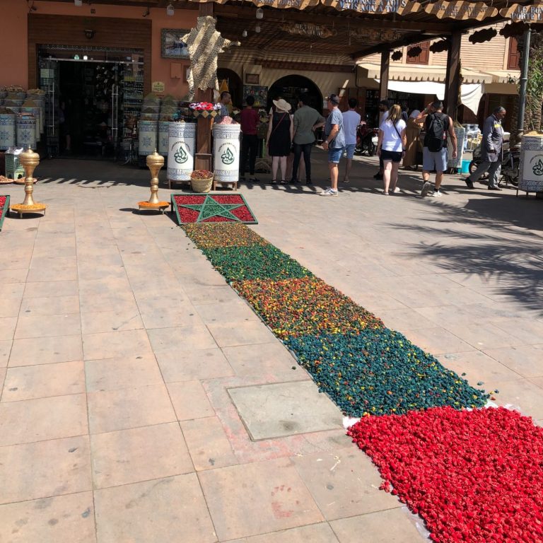 A stunning waterfall cascading down rocky cliffs, surrounded by lush greenery.