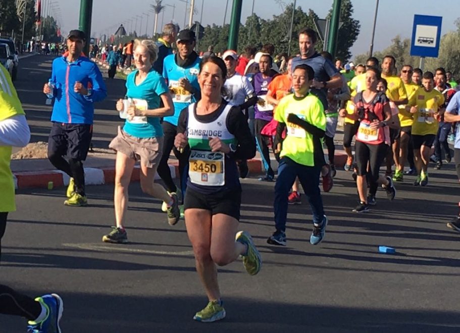 A lively group of runners participating in a race on a sunny day.